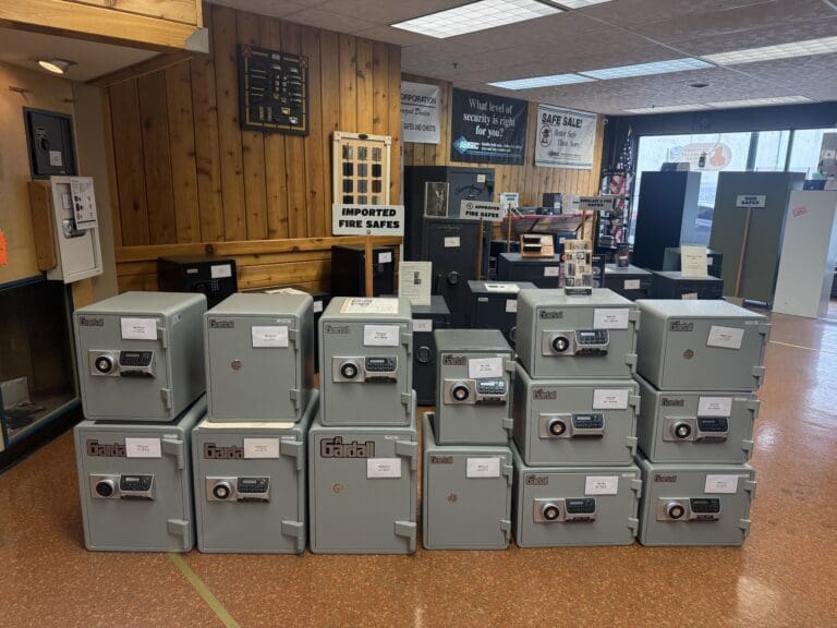 Display of various fireproof safes stacked in a wizard lock and safe store